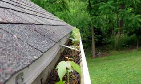 Clogged gutter ready for servicing by A&A Seamless Gutters, LLC