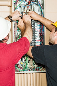 2 Oakwood Electric & Generator Electricians working on an electrical panel