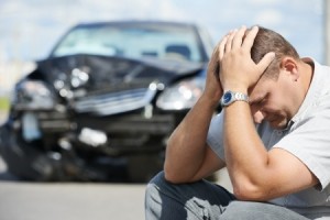 A man on the side of the road after a car accident