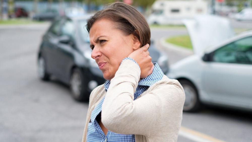 Una mujer con molestias en el cuello después de chccar