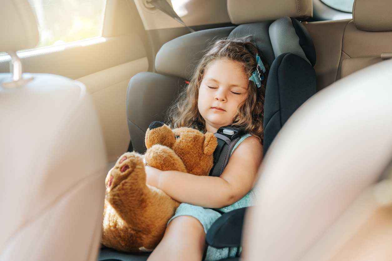 Una niña durmiendo en un carro